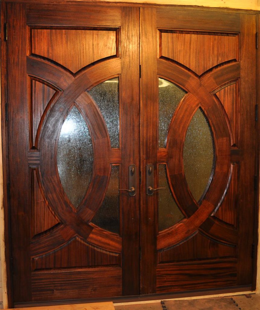 Completed custom exterior doors (African mahogany, rain finish glass, Endura Trilennium® locking system).