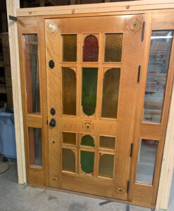 Custom wood door entry system with sidelights, 2.5" thick white oak.