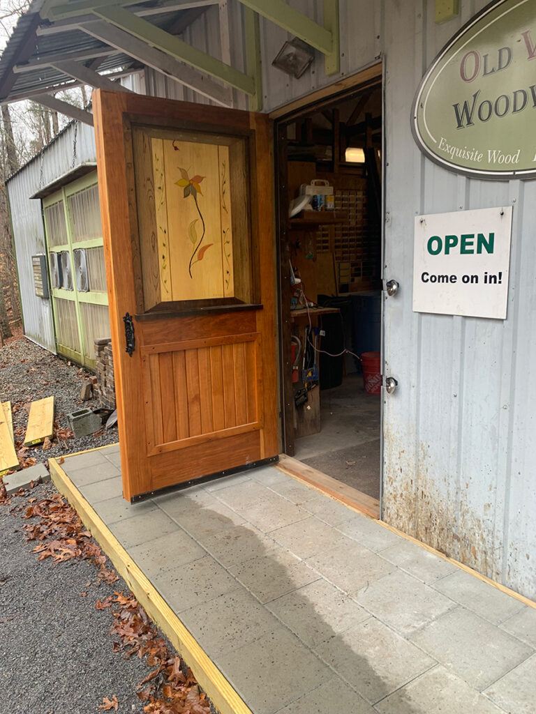Fully installed custom hardwood exterior door with art panel.